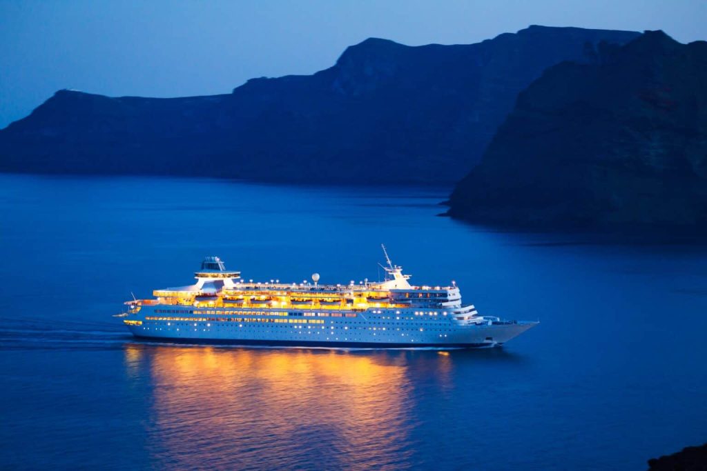 cruise ship in the water at night time