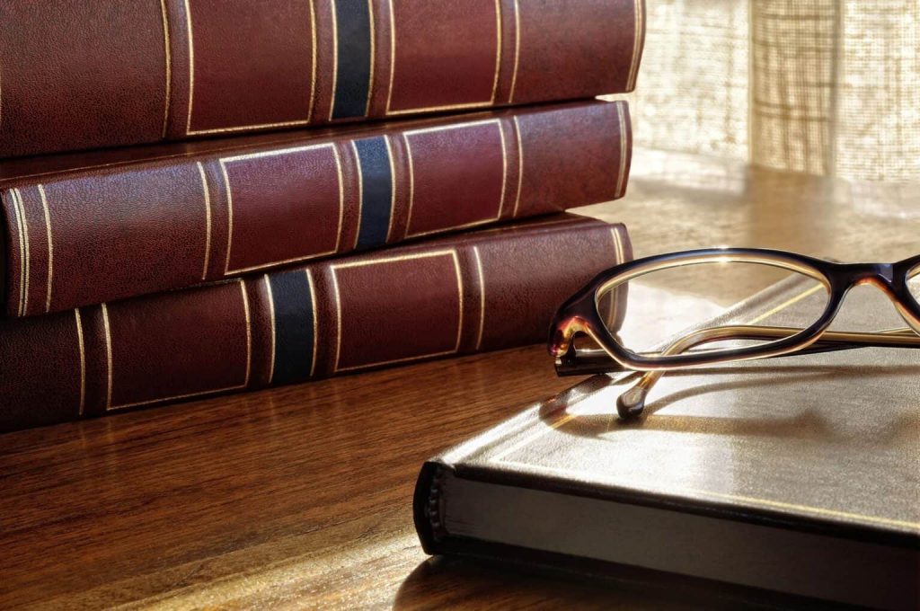 legal-books-on-desk-with-glasses